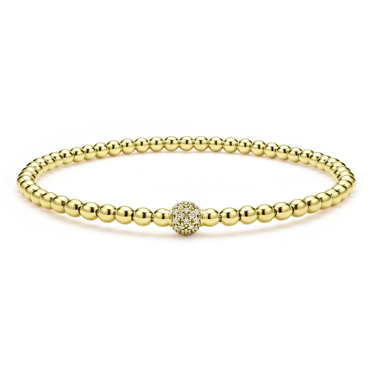 A single pavé diamond sphere on an 18K gold Caviar beaded stretch bracelet.