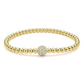 A single pavé diamond sphere on an 18K gold Caviar beaded stretch bracelet.