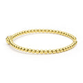 Gold beaded bracelet on a white background