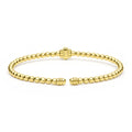 Gold beaded bracelet on a white background