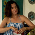 Parker Posey wearing thick sterling silver beaded bracelet with gold x details