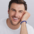 Man wearing LAGOS ultramarine blue Caviar ceramic beaded bracelet in 9 mm with sterling silver clasp