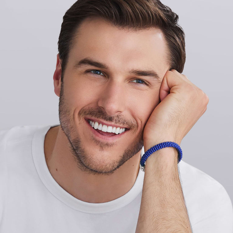 Man wearing LAGOS ultramarine blue Caviar ceramic beaded bracelet in 9 mm with sterling silver clasp