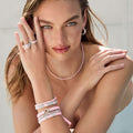 Model wearing pink ceramic bracelet stack