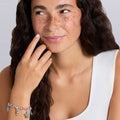 Woman wearing sterling silver beach charm bracelet