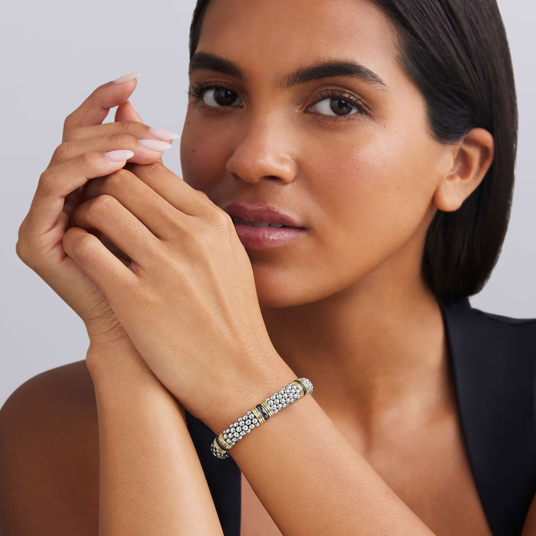 woman wearing 9mm sterling silver beaded bracelet with black ceramic and gold details