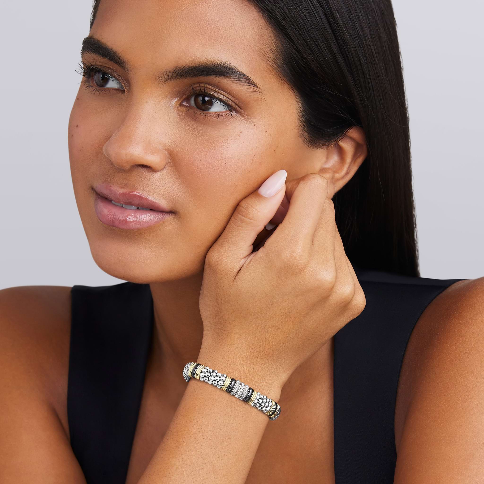 woman wearing 9mm sterling silver beaded diamond bracelet with black ceramic and gold stations