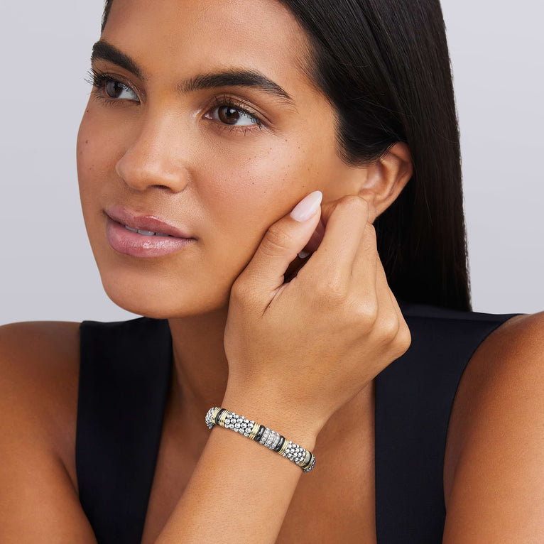 woman wearing 9mm sterling silver beaded diamond bracelet with black ceramic and gold stations