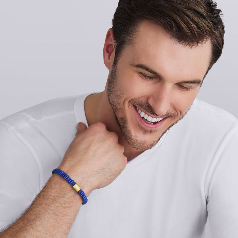 man wearing LAGOS 18K Gold matte blue ceramic Caviar bracelet, 9mm