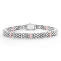 Seven smooth pink ceramic stations highlight sterling silver Caviar beading on this signature bracelet.