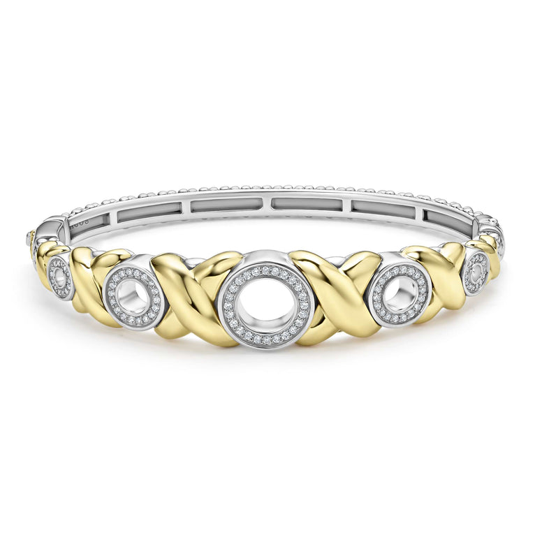 Five diamond circles set in 18K gold X-motifs accent this sterling silver Caviar beaded bracelet. LAGOS diamonds are the highest quality natural stones.