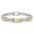 Sterling silver Caviar beading accented by three 18K gold X stations form this detailed LAGOS bracelet.