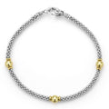 Three smooth stations of 18K gold and sterling silver Caviar beading form this rope bracelet.