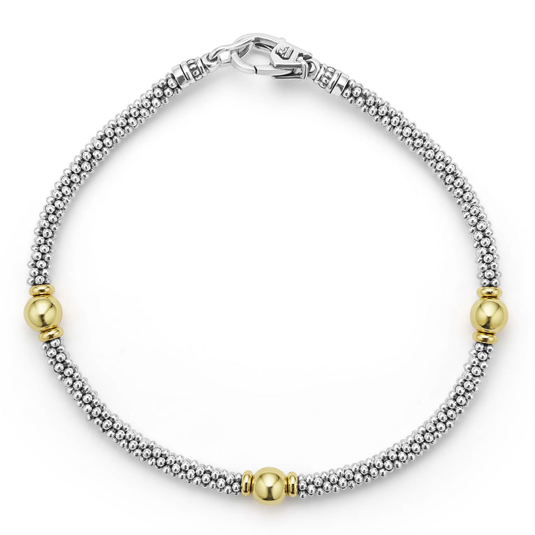 Three smooth stations of 18K gold and sterling silver Caviar beading form this rope bracelet.