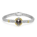 A tahitian black pearl surrounded by diamonds and smooth sterling silver Caviar beading and 18K gold stations forms this bracelet. LAGOS diamonds are the highest quality natural stones.