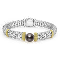 A sterling silver Caviar bracelet with a tahitian black pearl accented by 18K gold stations.