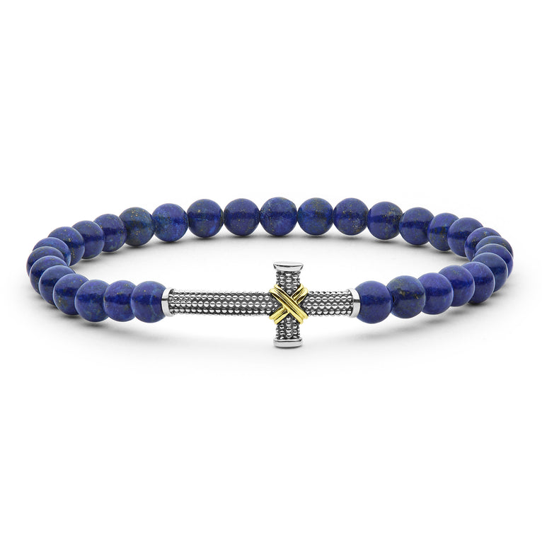 Blue beaded bracelet with a silver and gold cross charm on a white background