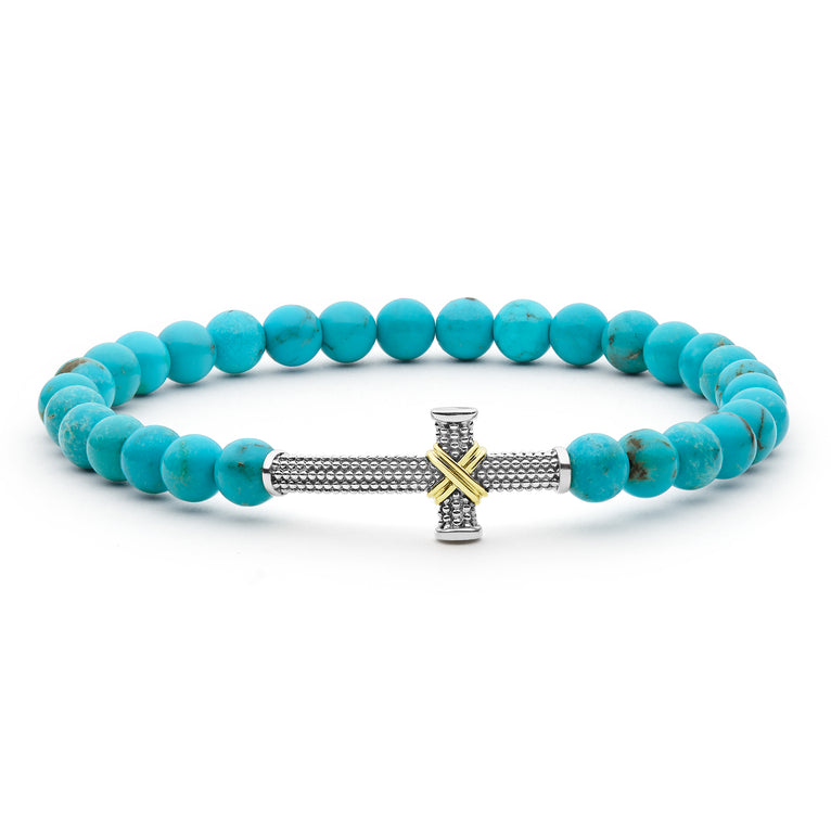 Turquoise beaded bracelet with a silver and gold cross charm on a white background