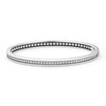 Diamonds accented by smooth sterling silver form this bangle bracelet. LAGOS diamonds are the highest quality natural stone.
