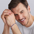 man wearing LAGOS Blue Caviar three-silver-station matte blue ceramic bracelet, 3 mm width, sterling silver lobster clasp