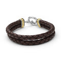 Brown braided leather bracelet with gold and silver clasp on a white background