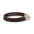 Brown braided leather bracelet with a silver and gold clasp on a white background
