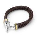 Brown braided leather bracelet with silver and gold clasp on a white background