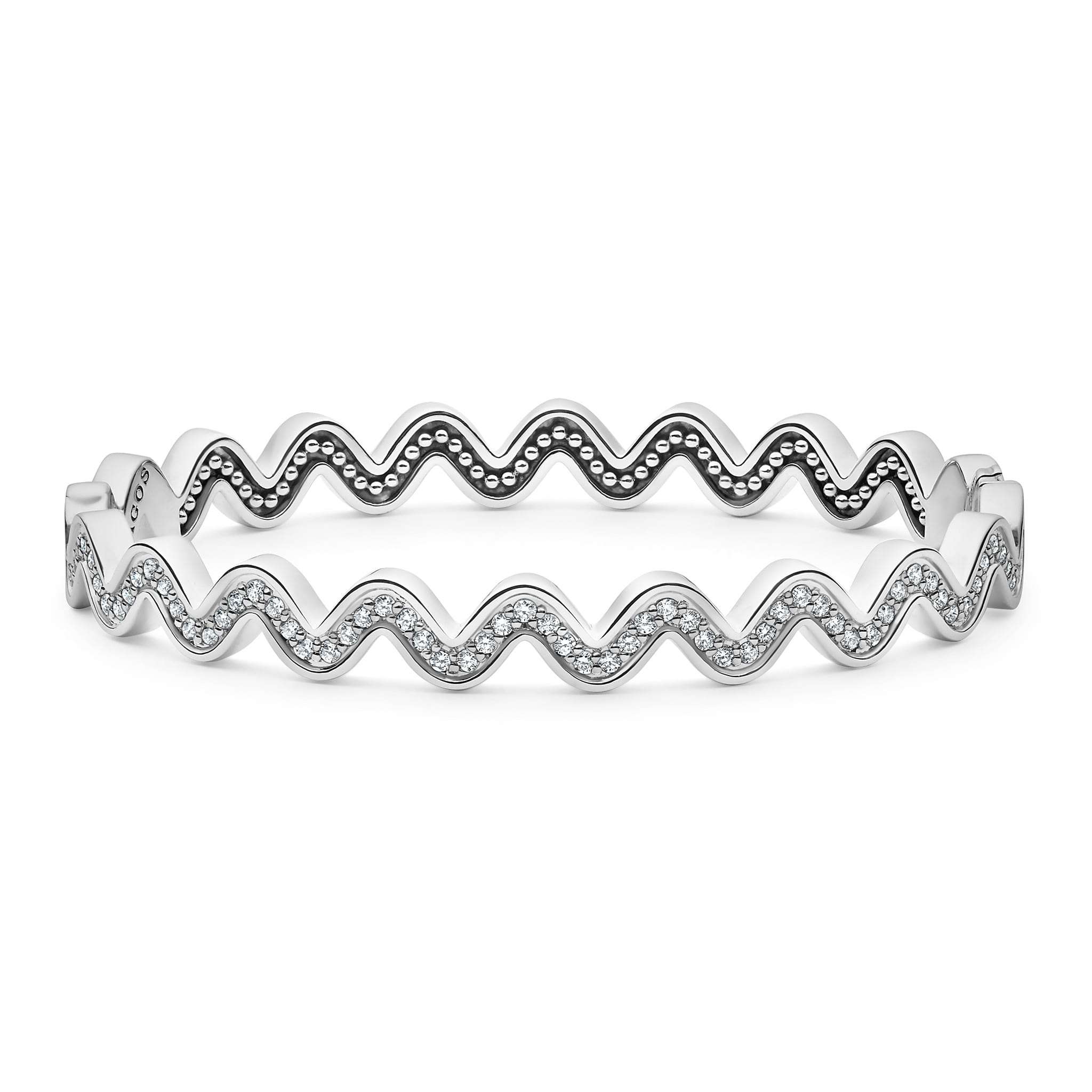 Sterling silver and diamonds form this wave bangle bracelet. LAGOS diamonds are the highest quality natural stones.