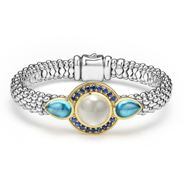 A round moonstone, blue sapphires, and pear-shaped blue topaz gemstones are set in smooth 18k gold on this sterling silver Caviar rope bracelet.