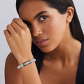 woman wearing 9mm sterling silver beaded diamond bracelet with black ceramic and gold details