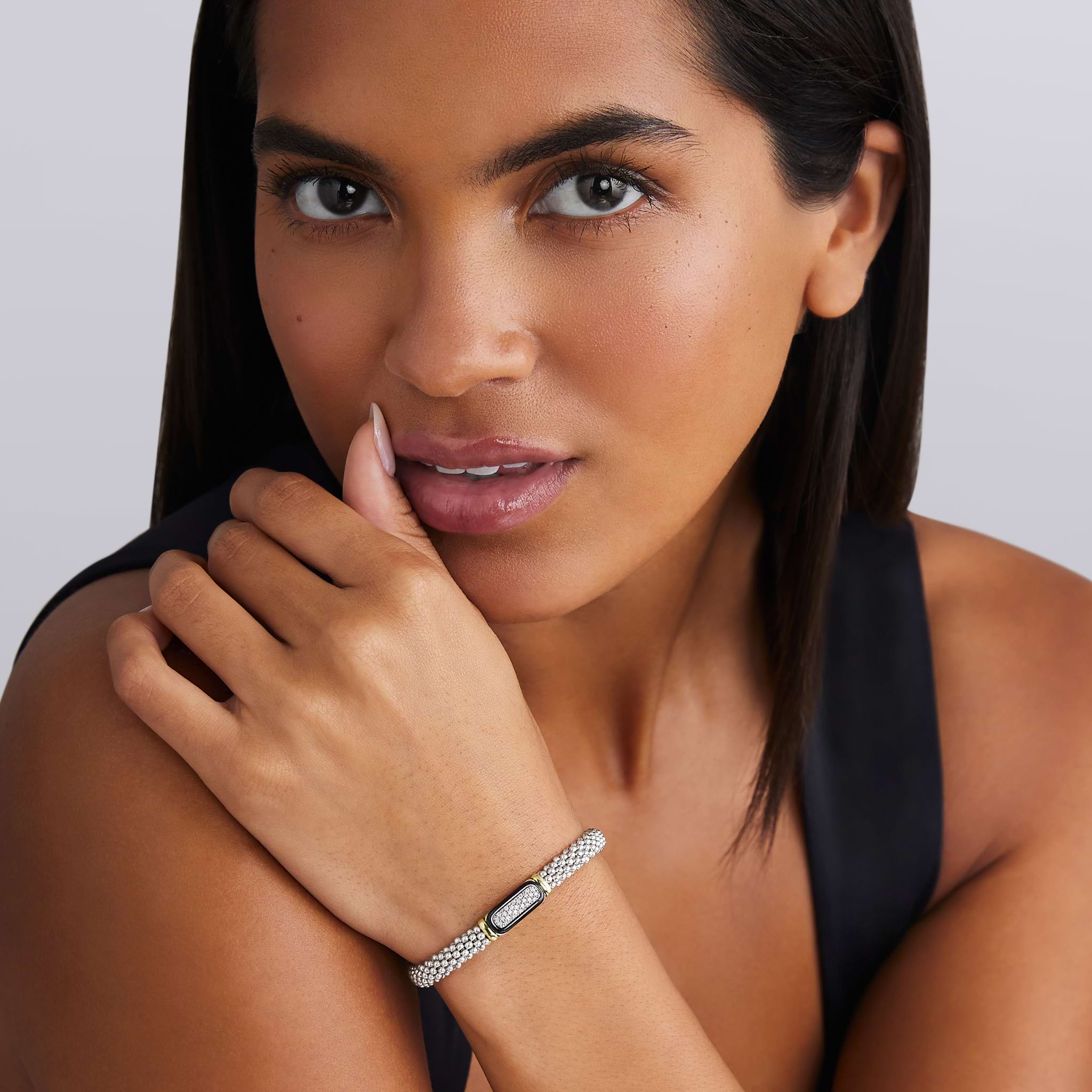 woman wearing 6mm sterling silver beaded diamond bracelet with black ceramic and gold details