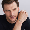 man wearing everyday stretch bracelet with beaded sterling silver and gold cross detail