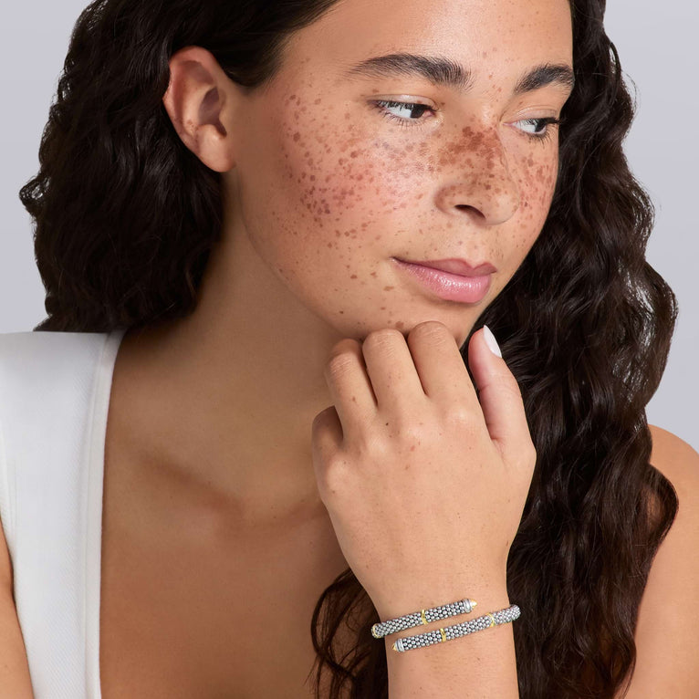 woman wearing 5mm sterling silver bypass beaded bracelet with gold stations
