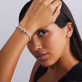 woman wearing sterling silver beaded stretch bracelet with diamonds and gold ring details 