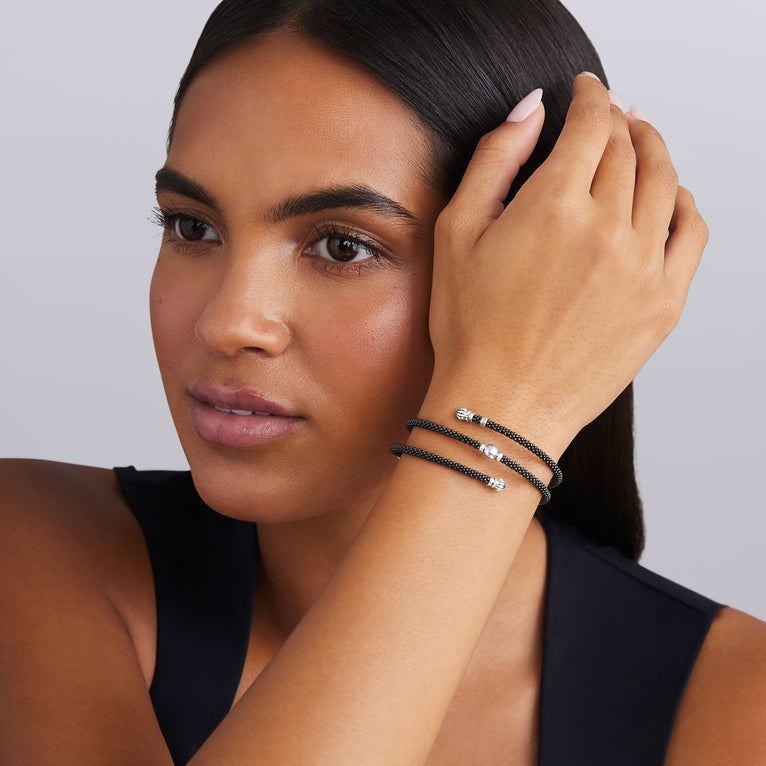 woman wearing black ceramic beading with sterling silver station wrap bracelet