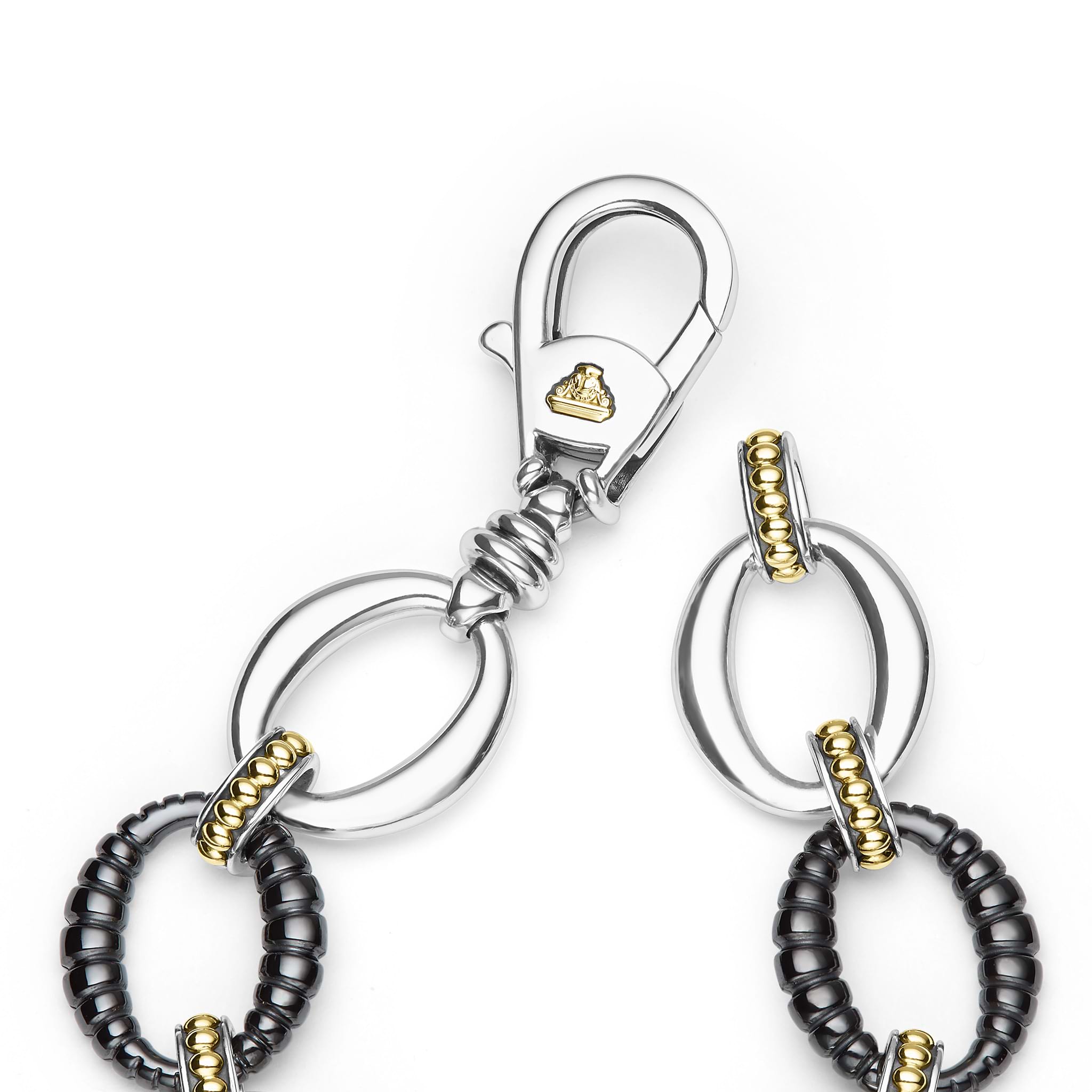 clasp of sterling silver link bracelet with gold and black ceramic beading 