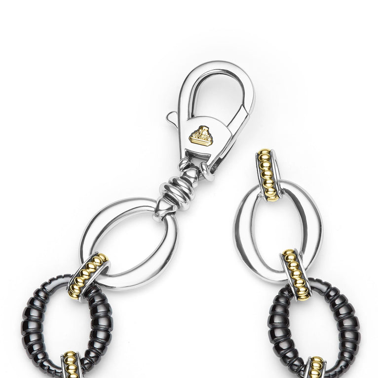 clasp of sterling silver link bracelet with gold and black ceramic beading 