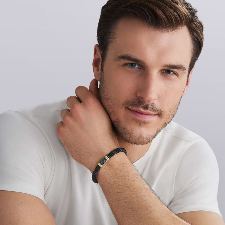 man wearing LAGOS 18K Gold matte black ceramic Caviar bracelet with black diamond station, 9mm