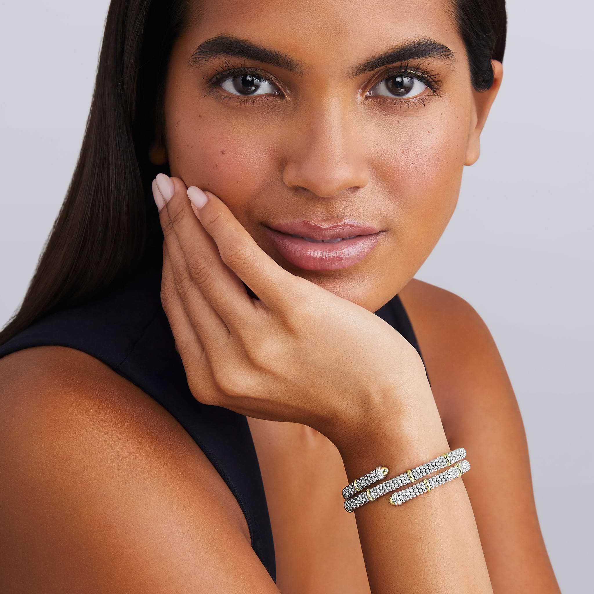 woman wearing 5mm sterling silver wrap bracelet with gold beaded accents