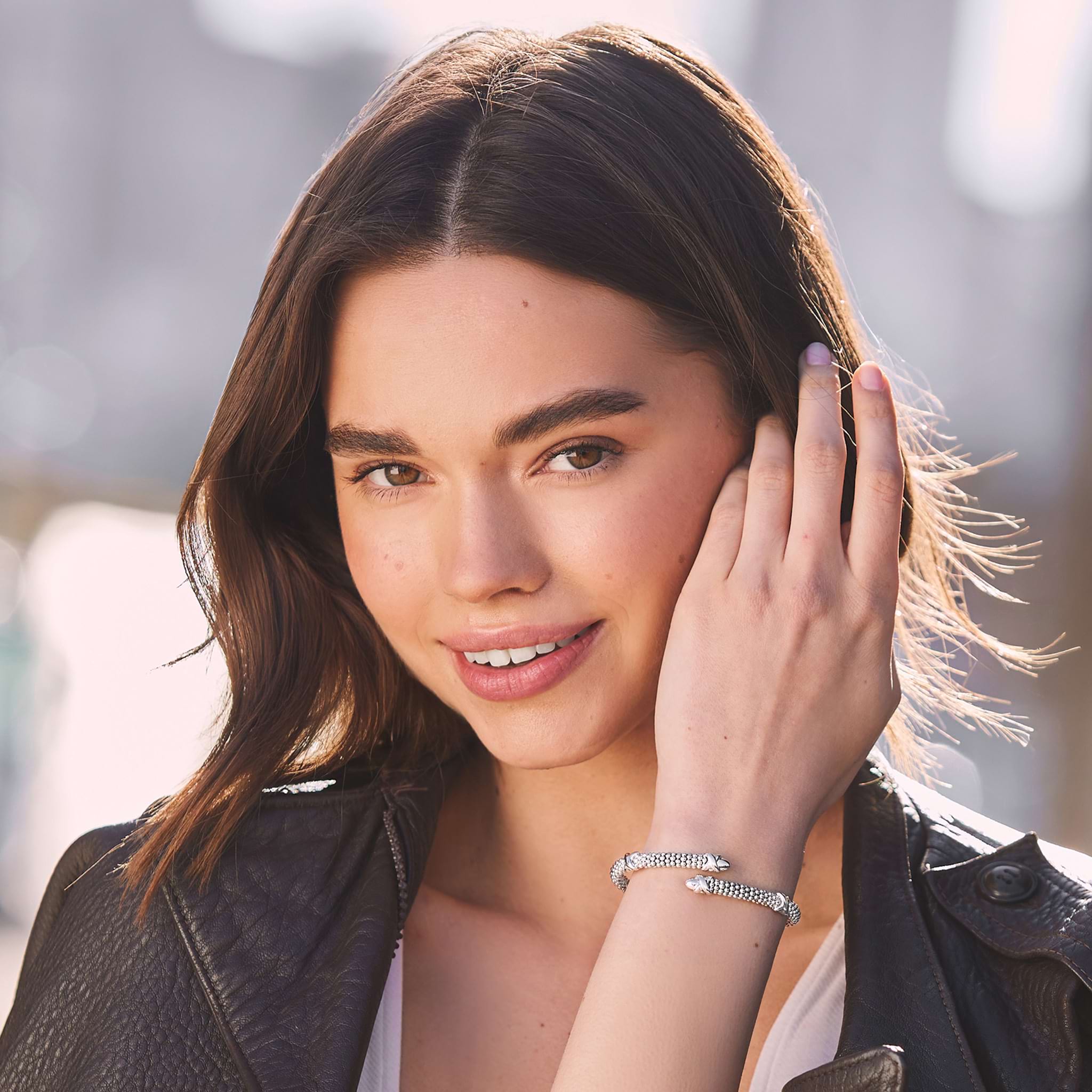 woman wearing 5mm sterling silver bypass bracelet with X stations