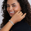 Person wearing the Signature Caviar Silver Interlocking Diamond Link Bracelet, showcasing its elegant design with interlocking links and sparkling diamonds, highlighting fine craftsmanship and sophistication.
