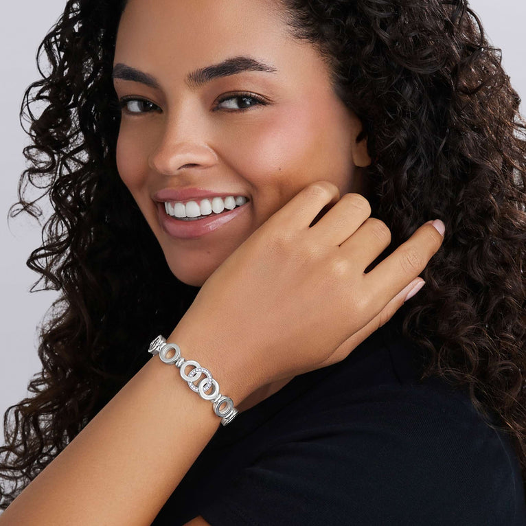 Person wearing the Signature Caviar Silver Interlocking Diamond Link Bracelet, showcasing its elegant design with interlocking links and sparkling diamonds, highlighting fine craftsmanship and sophistication.