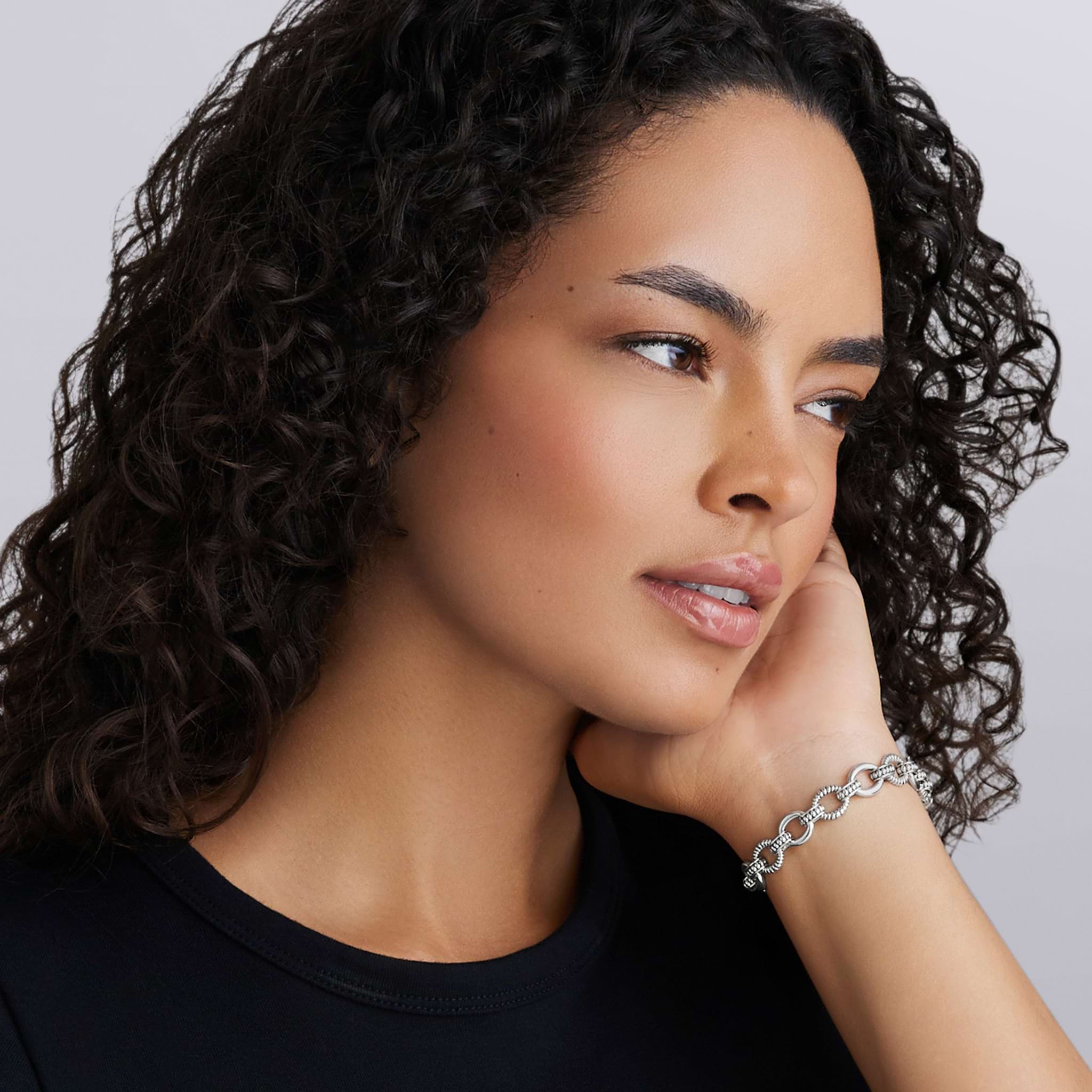 Signature Caviar Sterling Silver Fluted Oval Link Bracelet on wrist, showcasing chunky, textured links, highlighting LAGOS dedication to elegance and craftsmanship.
