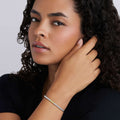 Woman wearing the Caviar Icon Two-Tone Caviar Icon Stretch Bracelet, featuring polished silver and gold beads, showcasing elegant LAGOS craftsmanship.