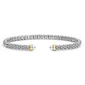 Signature Caviar Two-Tone Mini Versa Torque Bracelet with polished silver beads and 14K gold tips, showcasing LAGOS elegance and quality craftsmanship in a 3mm flexible design.