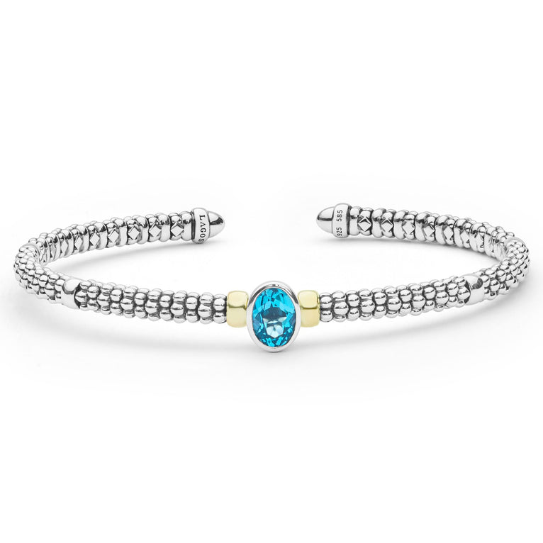  3mm features sterling silver caviar beading, 18K gold accents, and a faceted blue topaz centerpiece.