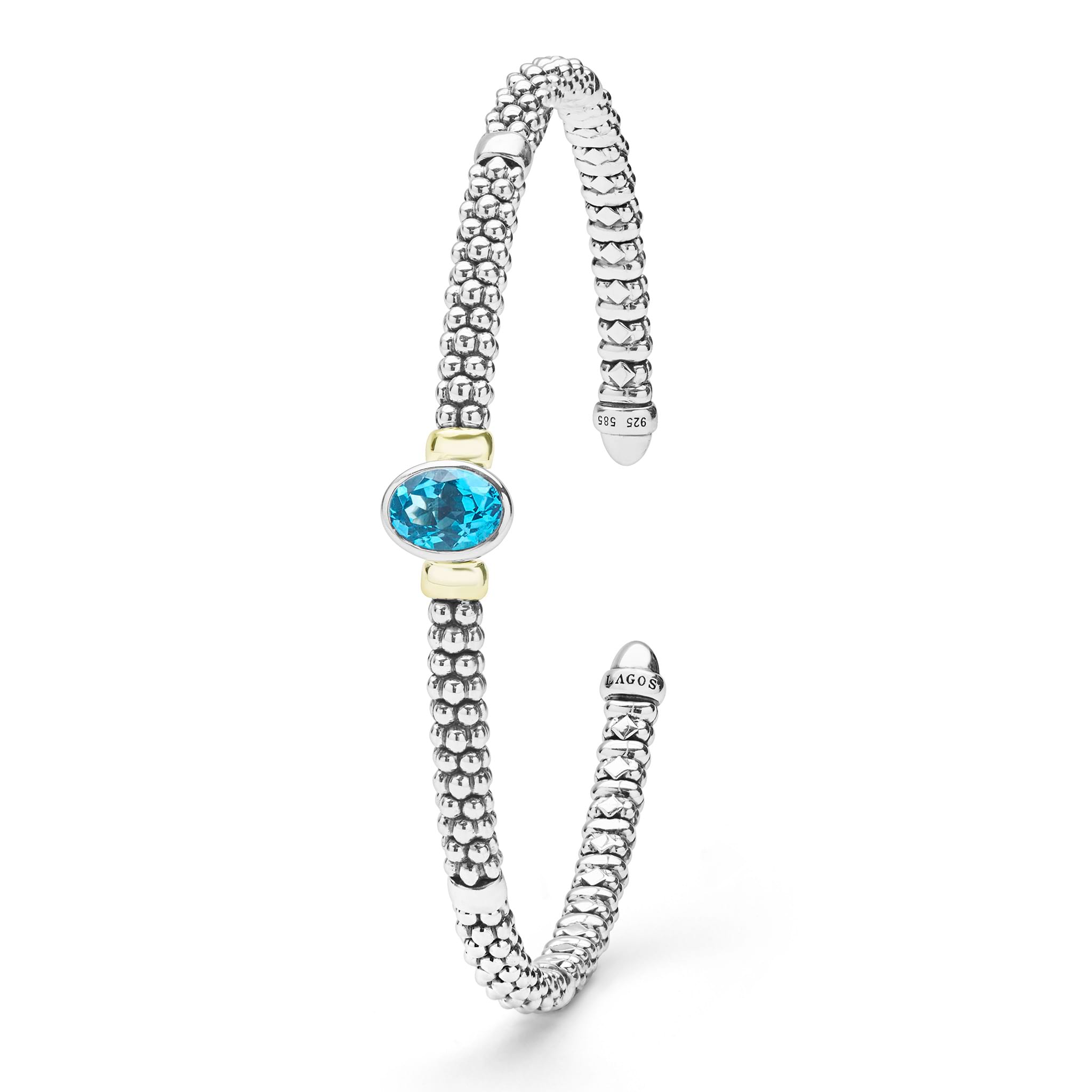  3mm features sterling silver caviar beading, 14K gold accents, and a vibrant oval blue topaz.