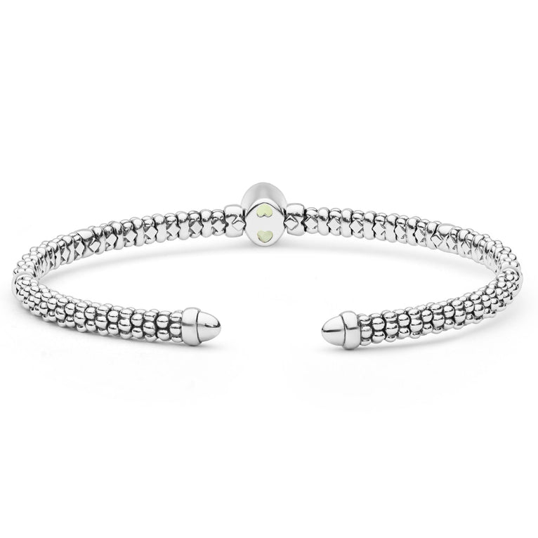 Signature Caviar Two-Tone Peridot Oval Mini Versa Torque Bracelet features sterling silver caviar beading with 14K gold stations and a vibrant peridot gemstone centerpiece.