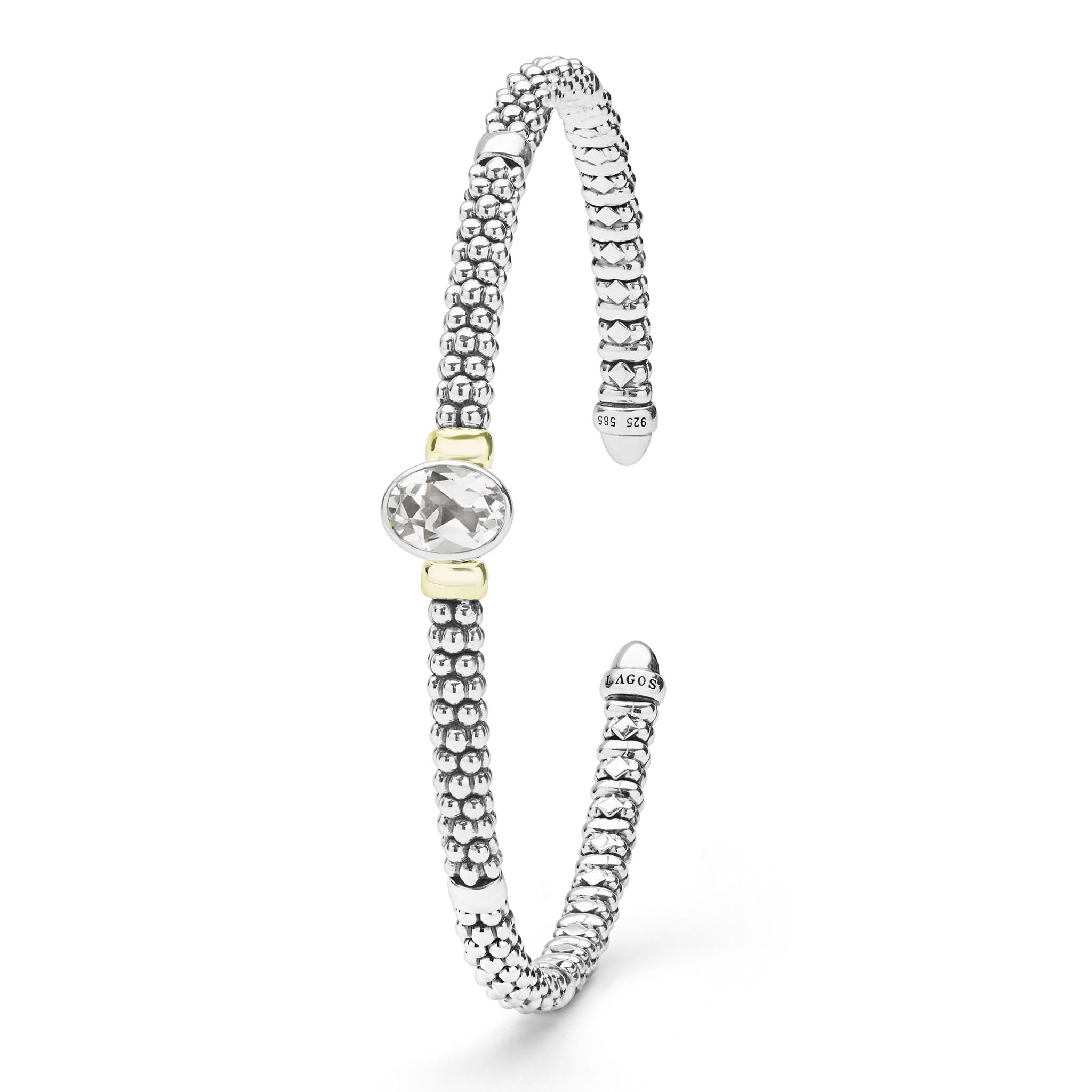 Signature Caviar Two-Tone White Topaz Oval Mini Versa Torque Bracelet features sterling silver caviar beading, 14K gold accents, and a central faceted white topaz gemstone.