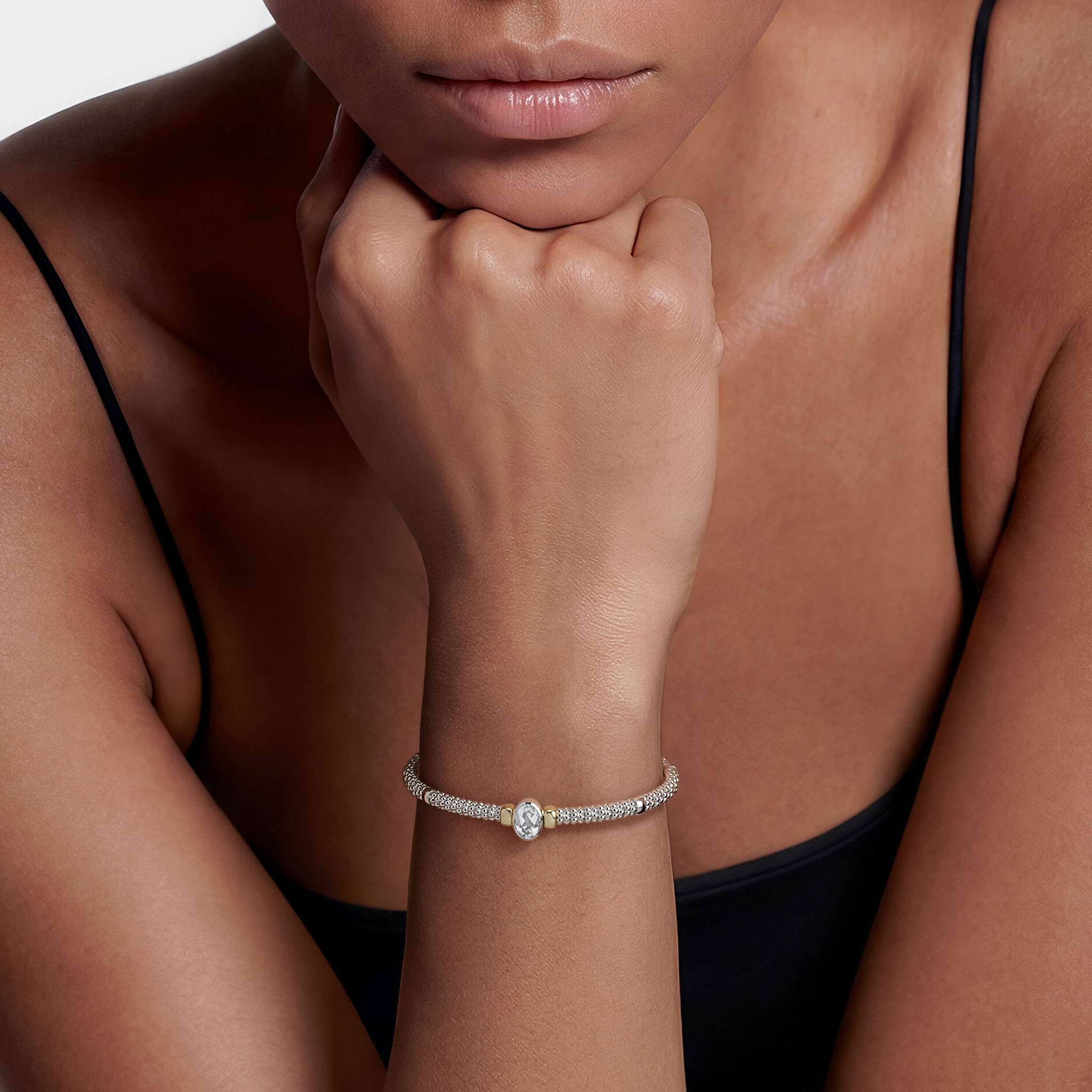  3mm shown on wrist, showcasing sterling silver caviar beading and 14K gold accents with a central white topaz.